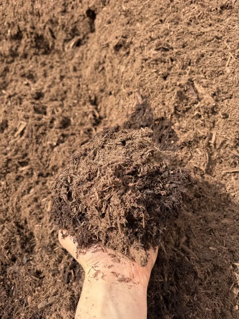 Close-up of premium shredded hardwood mulch used for professional landscape mulch installation by BlackRock Outdoor Living.