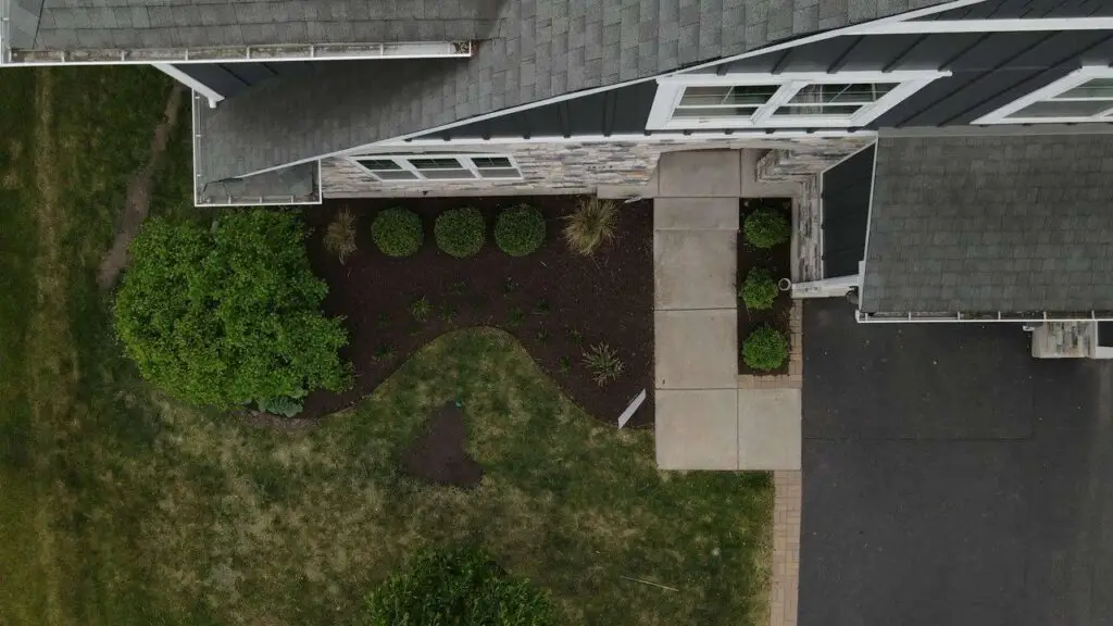Professional spring cleanup and new landscape installation featuring freshly mulched garden beds, newly planted shrubs, and a revitalized front yard in Barrington, IL.